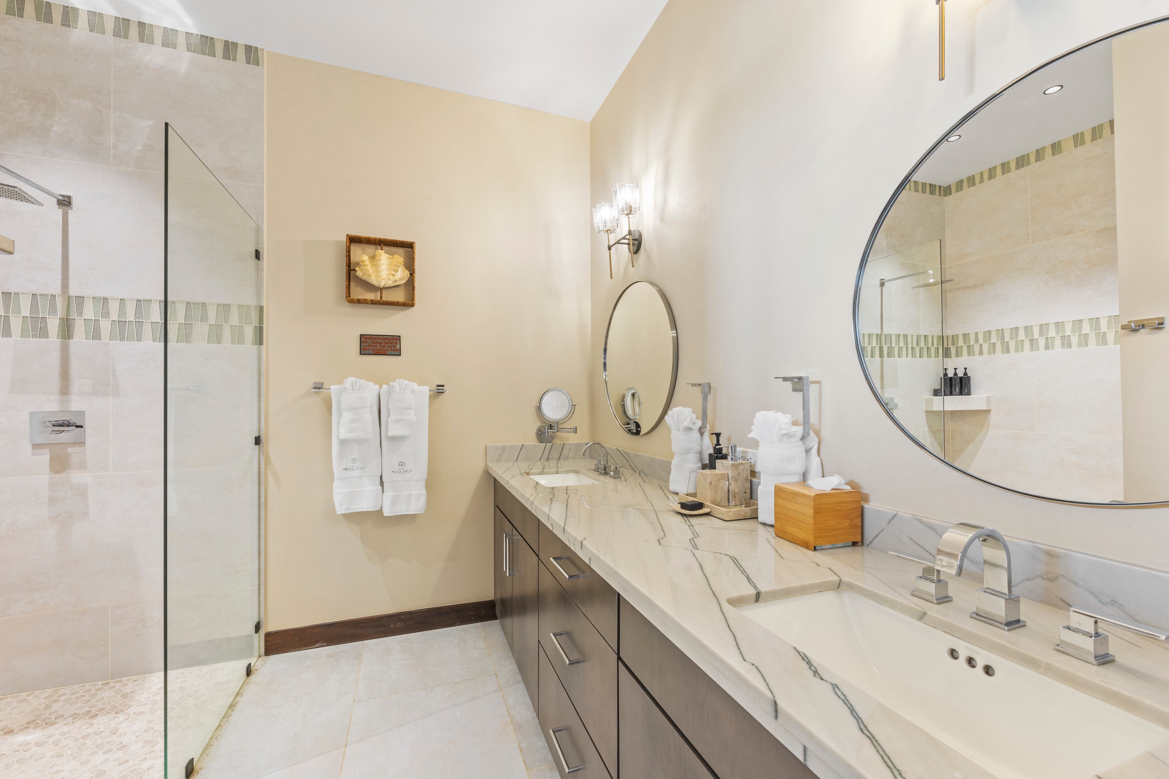 Modern bathroom with a walk-in shower, double sink vanity, and stylish decor.