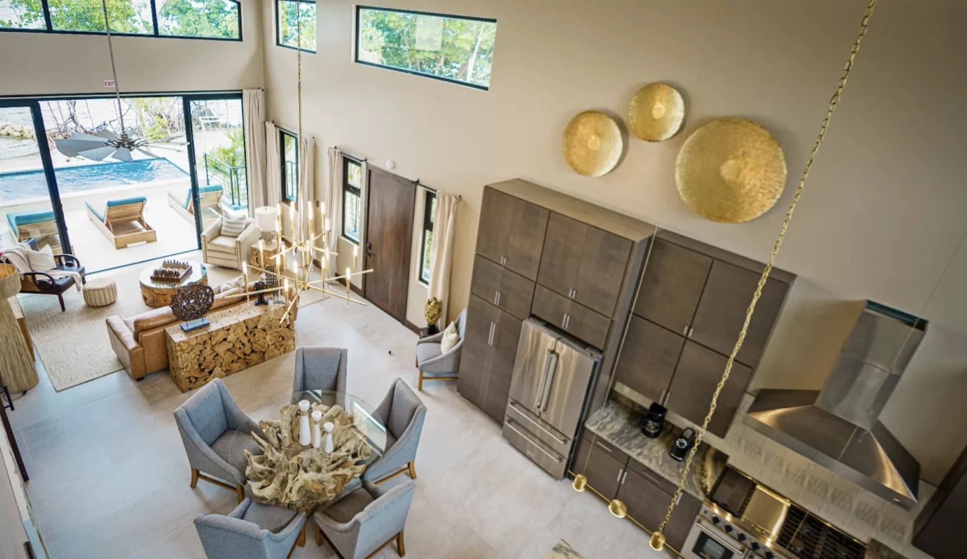A modern open-concept kitchen and dining area with large windows and stylish decor.