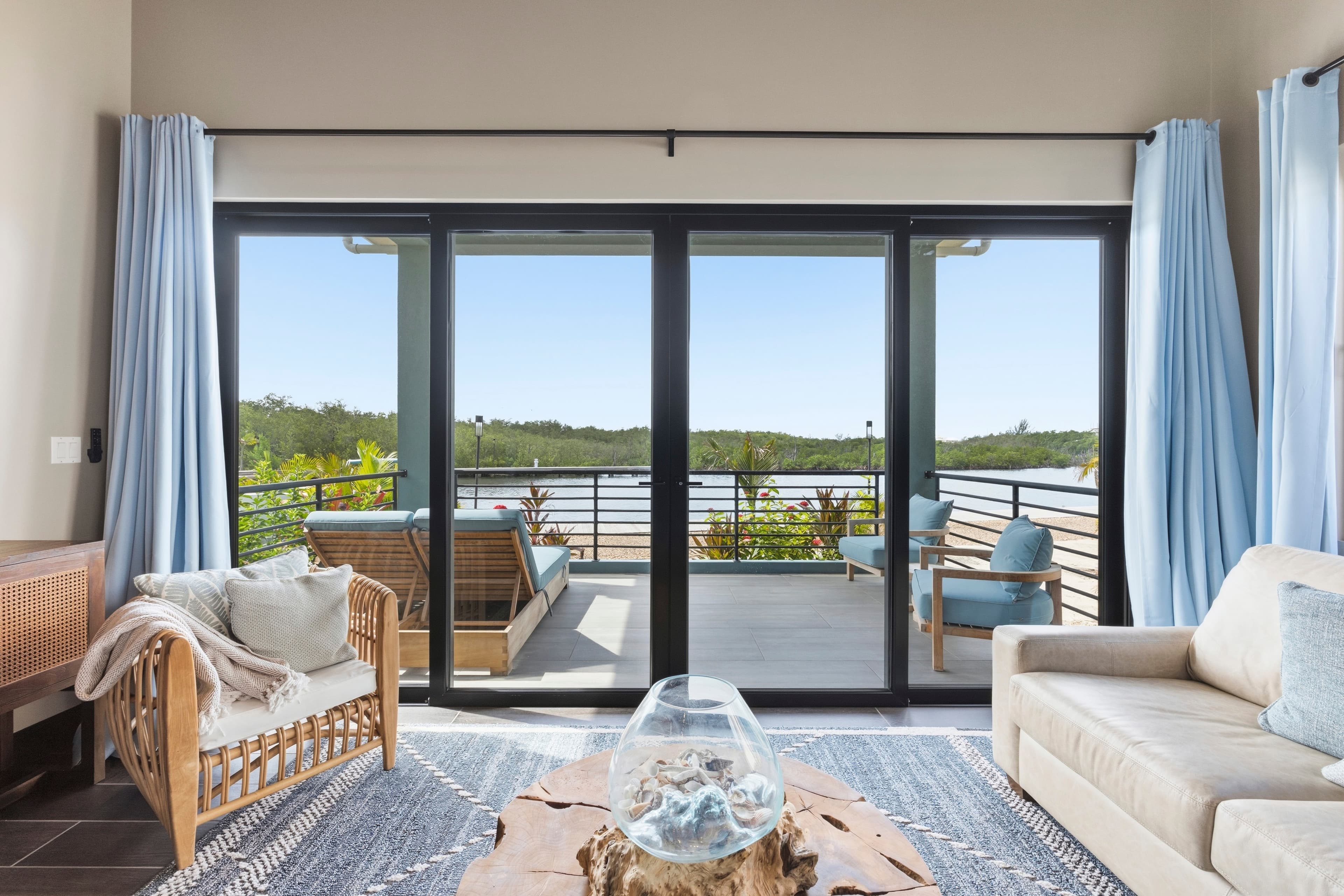 Modern living room with a view overlooking a balcony and natural scenery.